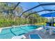 Beautiful screened-in pool with blue water, patio furniture, and plenty of room for entertaining at 7103 Westhill Ct, Lakewood Ranch, FL 34202