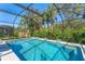 Screened-in pool with surrounding greenery, offering a private and relaxing outdoor space at 7103 Westhill Ct, Lakewood Ranch, FL 34202