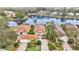 Scenic aerial view of a lakeside community featuring homes with tile roofs and well-maintained landscaping at 7327 Kensington Ct, University Park, FL 34201