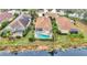 Aerial view of the property featuring a screened pool area and proximity to a scenic pond at 7327 Kensington Ct, University Park, FL 34201