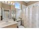 Bathroom featuring a large mirror, sink and walk-in shower at 7327 Kensington Ct, University Park, FL 34201