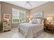 Comfortable bedroom with plantation shutters providing natural light at 7327 Kensington Ct, University Park, FL 34201