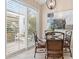 Bright breakfast nook with outdoor views and charming window treatments at 7327 Kensington Ct, University Park, FL 34201