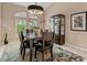 Comfortable dining space with dark wooden furniture and modern lighting fixtures at 7327 Kensington Ct, University Park, FL 34201