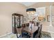 Dining area adjacent to kitchen featuring an elegant chandelier and display case at 7327 Kensington Ct, University Park, FL 34201