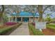 Charming fitness center entrance framed by lush landscaping and a welcoming 'Tennis & Fitness Centre' sign at 7327 Kensington Ct, University Park, FL 34201