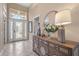 Bright foyer featuring tile flooring, an elegant mirror, and a decorative console table at 7327 Kensington Ct, University Park, FL 34201