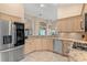 Well-lit kitchen with stainless steel appliances and granite countertops provides modern convenience at 7327 Kensington Ct, University Park, FL 34201