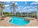 Beautiful backyard with a pool, spa, screened enclosure, and lush landscaping at 7327 Kensington Ct, University Park, FL 34201