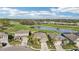 Aerial view of a house and neighborhood with golf course at 7812 Birdie Bend Way, Sarasota, FL 34241