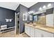 Double vanity bathroom with granite countertop and large mirror at 7812 Birdie Bend Way, Sarasota, FL 34241