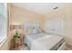 Cozy bedroom with a twin-size bed, nightstand and window at 7812 Birdie Bend Way, Sarasota, FL 34241