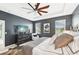 Large bedroom with king-size bed, TV, and ceiling fan at 7812 Birdie Bend Way, Sarasota, FL 34241