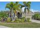 Single-story home with palm trees and well-manicured landscaping at 7812 Birdie Bend Way, Sarasota, FL 34241