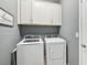 Laundry room with washer, dryer, and cabinets at 7812 Birdie Bend Way, Sarasota, FL 34241