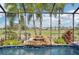 View of waterfall and lush landscaping surrounding the pool at 7812 Birdie Bend Way, Sarasota, FL 34241