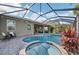 Enclosed pool and spa with waterfall feature and ample patio space at 7812 Birdie Bend Way, Sarasota, FL 34241