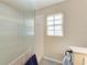 Bathroom with a shower and a window for natural light at 803 Montrose Dr # 201, Venice, FL 34293