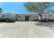 Two-story condo building with covered parking and lush landscaping at 803 Montrose Dr # 201, Venice, FL 34293