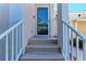 Inviting condo entry with a glass door and steps leading up to the front door at 803 Montrose Dr # 201, Venice, FL 34293