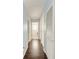 Light-blue hallway with dark wood flooring and laundry access at 803 Montrose Dr # 201, Venice, FL 34293