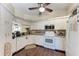 Well-equipped kitchen with white cabinetry and tile backsplash at 803 Montrose Dr # 201, Venice, FL 34293