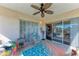 Screened in porch with wicker furniture and golf course view at 803 Montrose Dr # 201, Venice, FL 34293