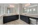 Double vanity bathroom with dark cabinets and a large mirror at 8063 Waterbend Trl, Sarasota, FL 34240