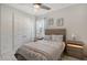 Guest bedroom with light gray walls and a floral bedspread at 8063 Waterbend Trl, Sarasota, FL 34240