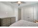 Guest bedroom with dresser and double doors at 8063 Waterbend Trl, Sarasota, FL 34240