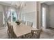 Bright dining room with large table and access to powder room at 8063 Waterbend Trl, Sarasota, FL 34240