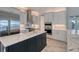 Spacious kitchen featuring white cabinets, a large island, and stainless steel appliances at 8063 Waterbend Trl, Sarasota, FL 34240