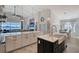 Open concept kitchen with large island and white shaker cabinets at 8063 Waterbend Trl, Sarasota, FL 34240