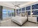 Main bedroom with water views, geometric wall, and large bed at 8063 Waterbend Trl, Sarasota, FL 34240