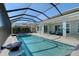 Relaxing pool and spa with screened enclosure and lake view at 8063 Waterbend Trl, Sarasota, FL 34240