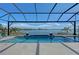 Luxury pool with screened enclosure, spa, and lake view at 8063 Waterbend Trl, Sarasota, FL 34240