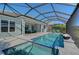 Stunning pool and spa with screened enclosure, fire features and lake view at 8063 Waterbend Trl, Sarasota, FL 34240