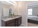 Bathroom featuring double granite vanity and view to the main bedroom at 8362 Enclave Way # 103, Sarasota, FL 34243