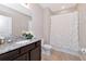 Bathroom featuring a toilet, bathtub with shower curtain and granite vanity at 8362 Enclave Way # 103, Sarasota, FL 34243