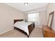 Bright bedroom with carpet, a window and medium-toned wood furniture at 8362 Enclave Way # 103, Sarasota, FL 34243