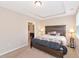 Main bedroom showcases a tray ceiling and ensuite bath at 8362 Enclave Way # 103, Sarasota, FL 34243