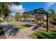 Bocce ball court area with seating in a shaded outdoor common area at 8362 Enclave Way # 103, Sarasota, FL 34243