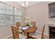 Breakfast nook with a dining table and seating for four underneath a decorative light fixture at 8362 Enclave Way # 103, Sarasota, FL 34243