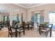 Inviting dining area with tables, chairs, and large mirrors for an open feel at 8362 Enclave Way # 103, Sarasota, FL 34243