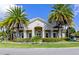 Well-manicured exterior with lush landscaping, complemented by mature palm trees at 8362 Enclave Way # 103, Sarasota, FL 34243