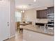 Kitchen features granite counters, stainless steel sink, and dark cabinetry at 8362 Enclave Way # 103, Sarasota, FL 34243