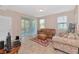 Living room with neutral paint, tile floors, and a brown leather sofa at 8362 Enclave Way # 103, Sarasota, FL 34243