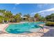 Large community pool with shallow area and lounge seating under shady canopies at 8362 Enclave Way # 103, Sarasota, FL 34243