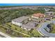 Aerial view showcases the apartment building, garages, parking, and landscape at 12410 Osorio Ct # 201, Sarasota, FL 34238