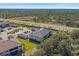 Overhead shot of apartment building, garages, and parking in a lush, green setting at 12410 Osorio Ct # 201, Sarasota, FL 34238